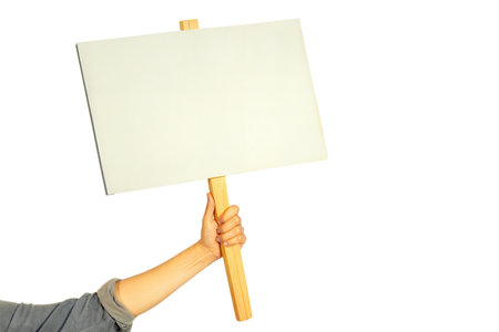 Close-up of a hand holding a blank sign with a wooden stick.  Perfect for adding your own message or text.の写真素材