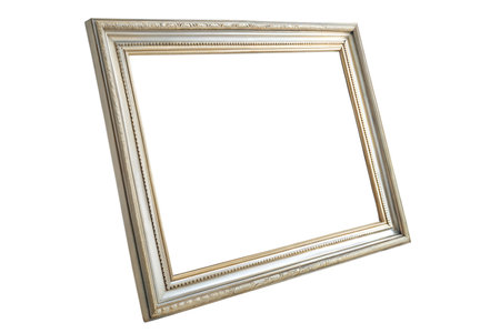 A close-up of an empty, ornate picture frame, angled against a black background.  The frame is off-white with gold accents.の写真素材