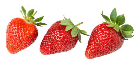 Close-up of three ripe strawberries isolated on a black background.  The image showcases their vibrant red color and detailed texture.の写真素材