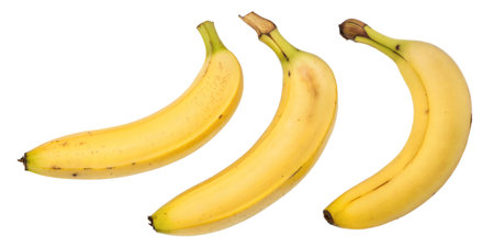 Three yellow bananas isolated on a black background.  Perfect for healthy eating or recipes.の写真素材