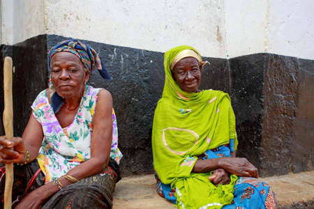 Wa, Ghana - November 8, 2012  Unidentified blind Ghanian woman with walking stick relaxes with her friend  Blindness and sight problems remain a big issue in Western Africaのeditorial素材