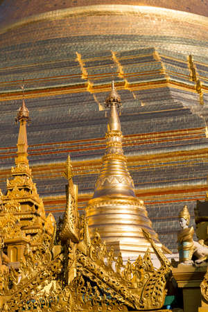 The beautiful multiple gold layers of the Shwedagon pagoda glisten in the early morning sun in Yangonの写真素材