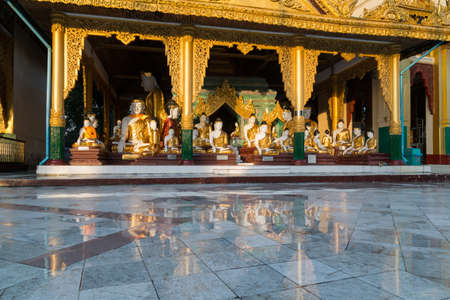 A beautiful temple, reflected in puddles after heavy rain at Shwedagon pagodaのeditorial素材