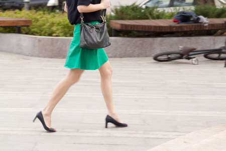 The girl is walking along the streetの写真素材