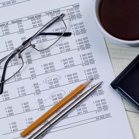 table with the results and the business detail with a cup of tea on the table