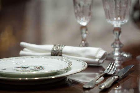 festively served table with beautiful plates and glassesの写真素材
