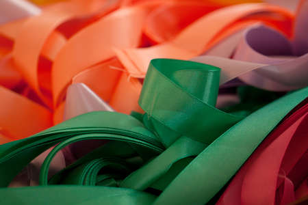 folded colorful bright silk ribbons prepared for decoration of a holiday or festivalの写真素材