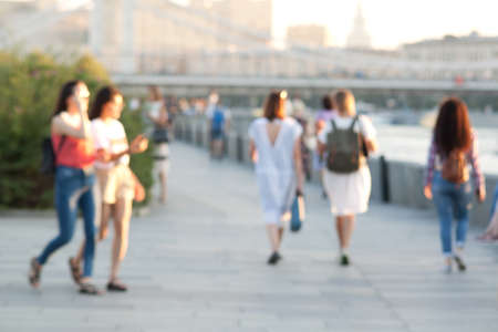 sunny urban summer landscape with people walking along the quayの写真素材