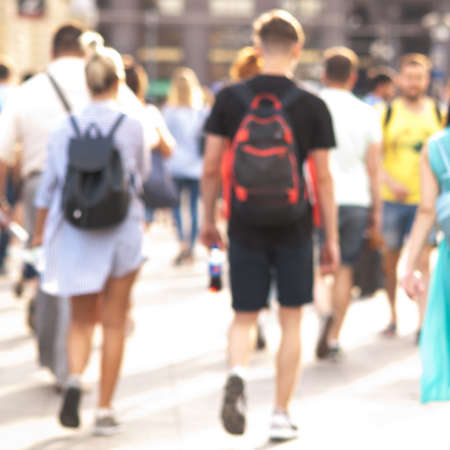 people take a leisurely walk through the summer sunny city, a blurred backgroundの写真素材