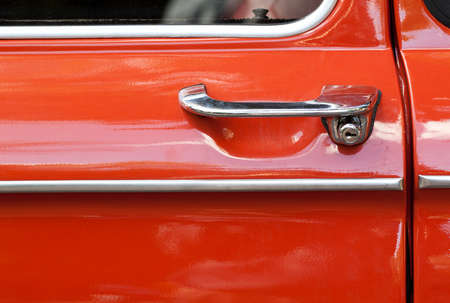 door of an old car with a beautifully shaped handleの写真素材