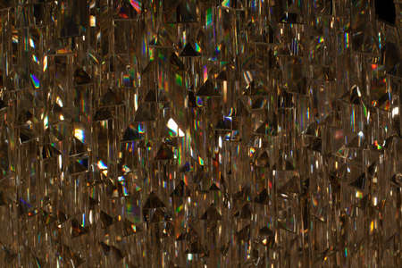 abstract bright and dark golden background of lines, triangles and highlights with iridescent stainsの写真素材
