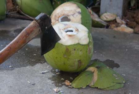 coconut and axe peeling coconuts by an axe.