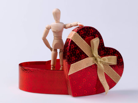 Heart Shaped Box with a wooden dollの写真素材