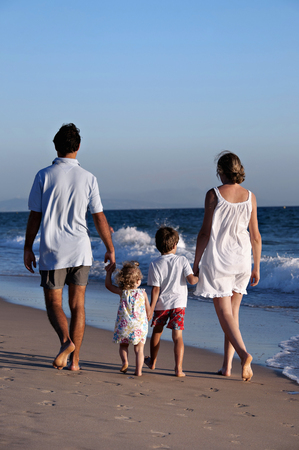 Family walking on the beachの写真素材