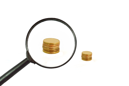 Looking for Money with a glass magnyingの写真素材