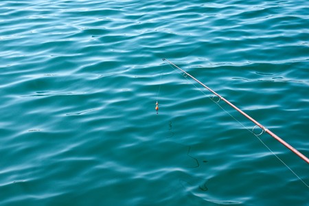 Fishing hook trown into the waterの写真素材