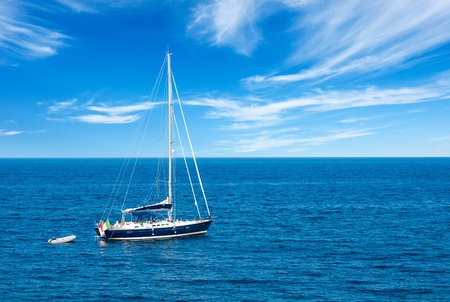 Luxury yatch in open waters with beautiful cloudsの写真素材