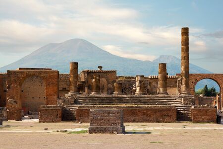 Ancient ruins of Pompei with volcano Vesuvius at back during sunset, Italyの写真素材