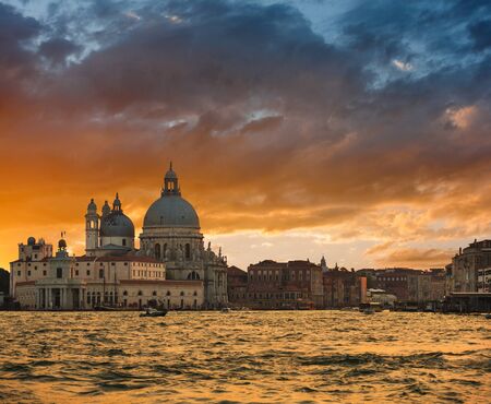 Gorgeous sunset over Grand Canal and Basilica Santa Maria della Salute, Venice, Italyの写真素材