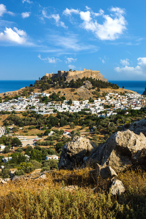 Town of Lindos and Acropolis on the island of Rhodes under puffy clouds, Greeceのeditorial素材