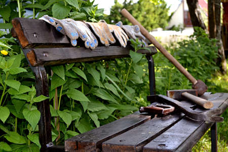 workers left for lunch, leaving the tools and gloves on the benchの写真素材