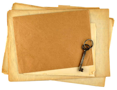 stack of old papers and old key isolated on whiteの写真素材