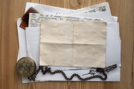 stack of old papers and letters on a wooden background