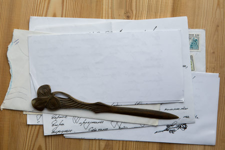 stack of old papers and letters on a wooden background