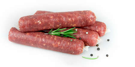 Raw meat sausages. Rosemary, pepper. White background.の写真素材