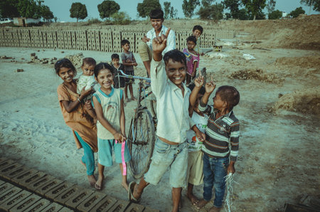 AMRITSAR, PUNJAB, INDIA - 21 APRIL 2017 : picture of Indian kids holding their younger siblingsのeditorial素材