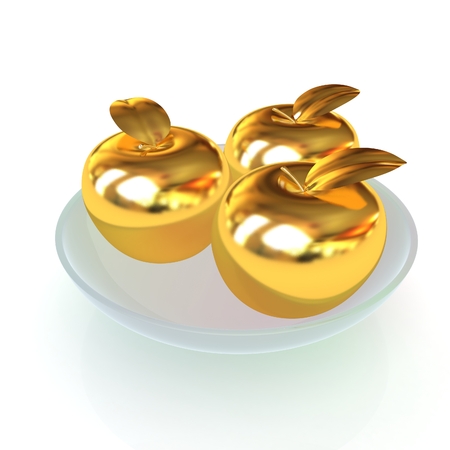 Gold apples on a plateの写真素材