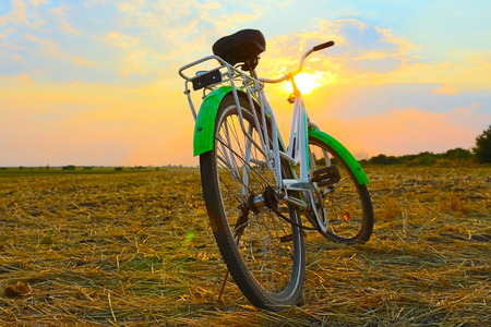 Bicycle in the stubble in a wheat fieldの写真素材