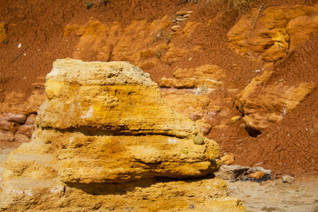 the surface texture of the slope from dry sand-clay granular soils with a reddish tinge