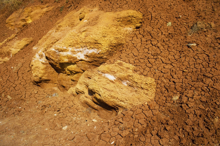 the surface texture of the slope from dry sand-clay granular soils with a reddish tingeの写真素材
