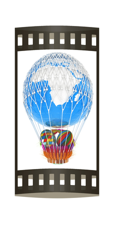 Hot Air Balloon of Earth with a basket of multicolored wheat and Easter eggs inside. 3d renderの写真素材