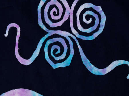 Colorful pattern on black fabric batik as backgroundの写真素材