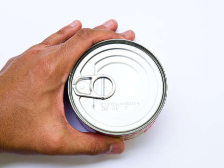 Food can in hand isolated on white backgroundの写真素材