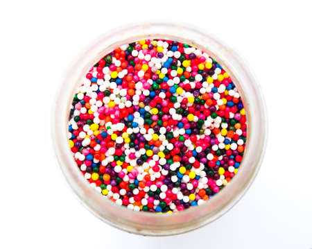 Sugar sprinkle dots in a bottle isolated in white background from topviewの写真素材