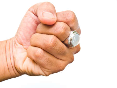 A guy fist with white jade ring on his finger isolated on white backgroundの写真素材
