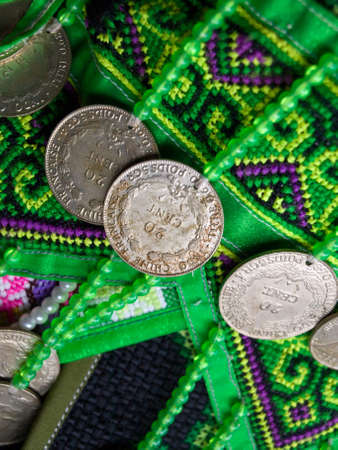 An Indo china french coins  decorated on the hill tribe traditional fabric from Chiang rai, Thailandの写真素材