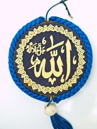 Close up of blue velvet Allah pendent isolated on white backgroundの写真素材