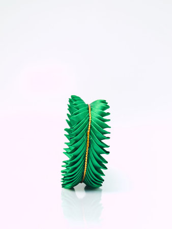 Side of miniature of Thai traditional tray made from green silk isolated on white backgroundの写真素材