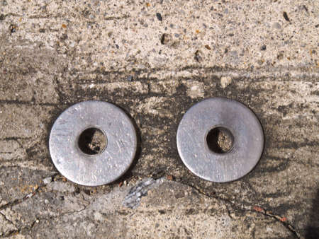 Double metal round plate on concreteの写真素材