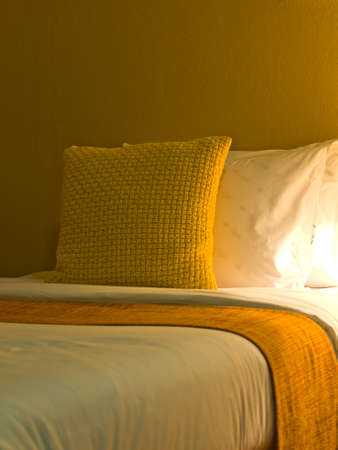 A design red pillow in a modern style bedroom interior with warm lightの写真素材