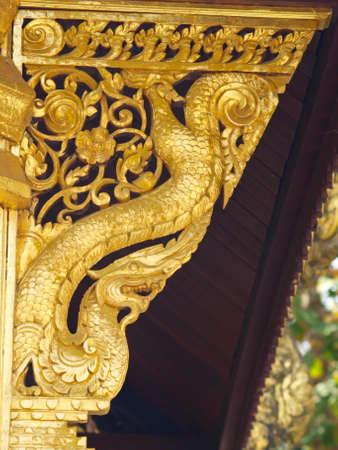 golden wooden carving buttress, Wat Phrathat chomkitti temple in Chiang rai, Thailand の写真素材