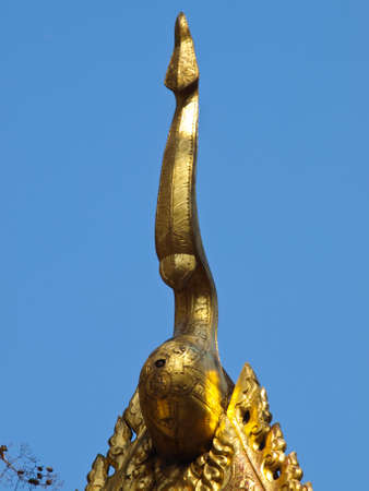 golden wooden carving of gable apex, Wat Phrathat chomkitti temple in Chiang rai, Thailand の写真素材