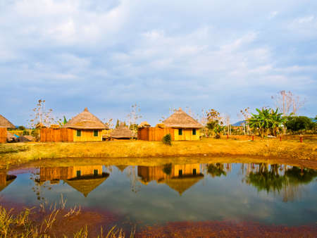 Bamboo cottages and and thier reflections in pond in Nakorn Ratchasima,Thailandの写真素材