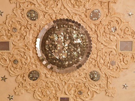 Closeup of white stucco and mirror decoration in the interior ceiling of historic old house in...