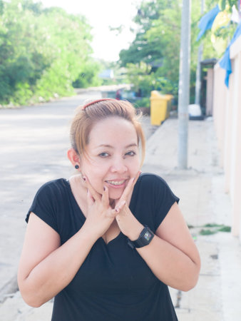 Happy young Asian lady smiling in nature