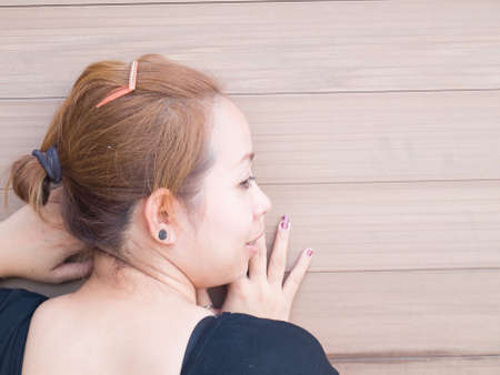 Closeup of back of young Asian lady looking on something in natureの写真素材
